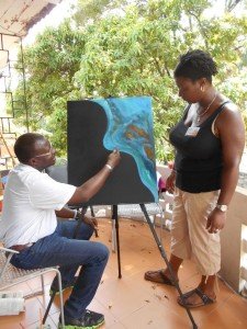 Haitian artist, Melchiade Domond discusses technique with Andrea